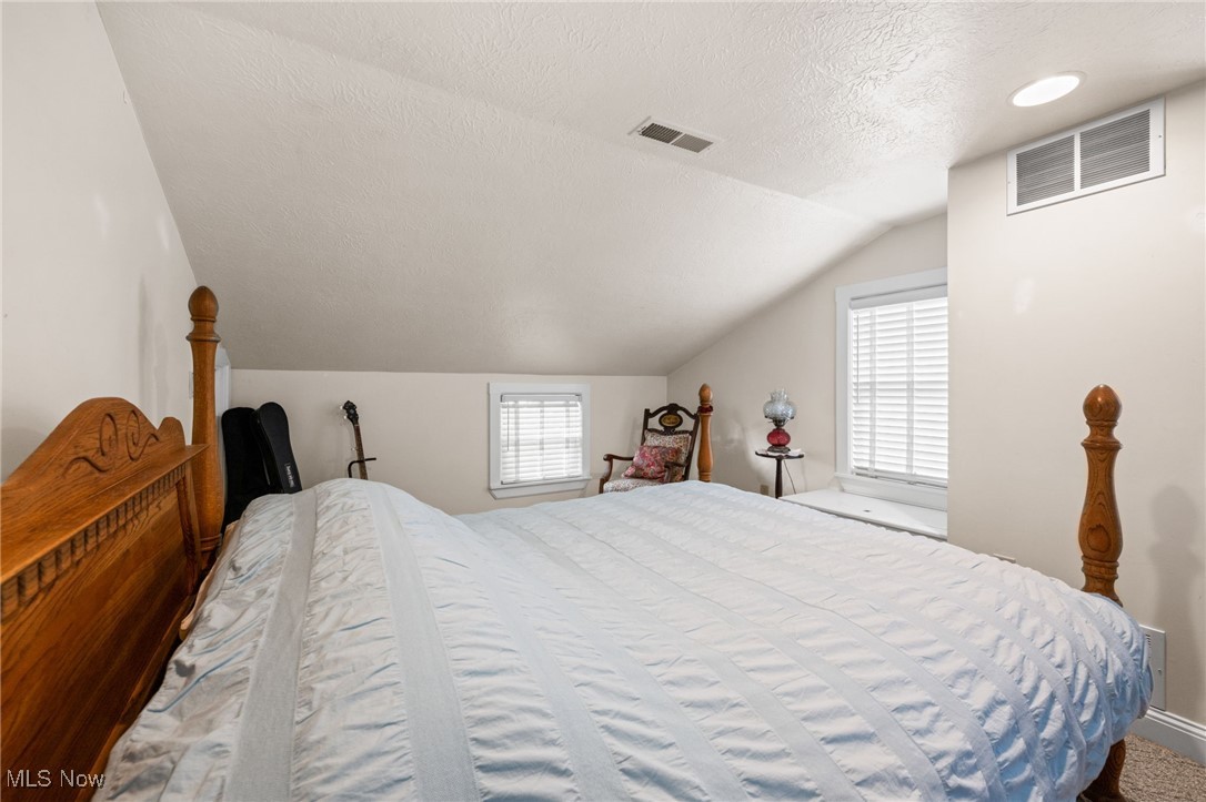 3945 Columbia Road Medina, OH 44256 - Photo 23 of 40 Bedroom with a textured ceiling and vaulted ceiling