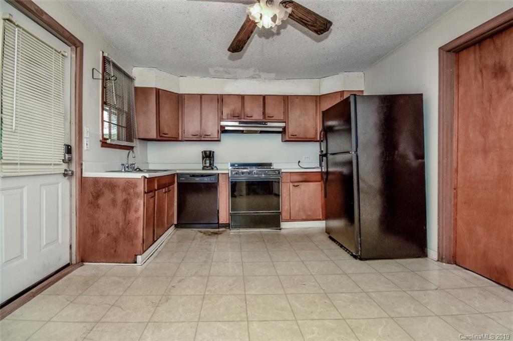 504 Watson Street Davidson, NC 28036 - Photo 20 of 35 a kitchen with stainless steel appliances granite countertop a refrigerator and a sink