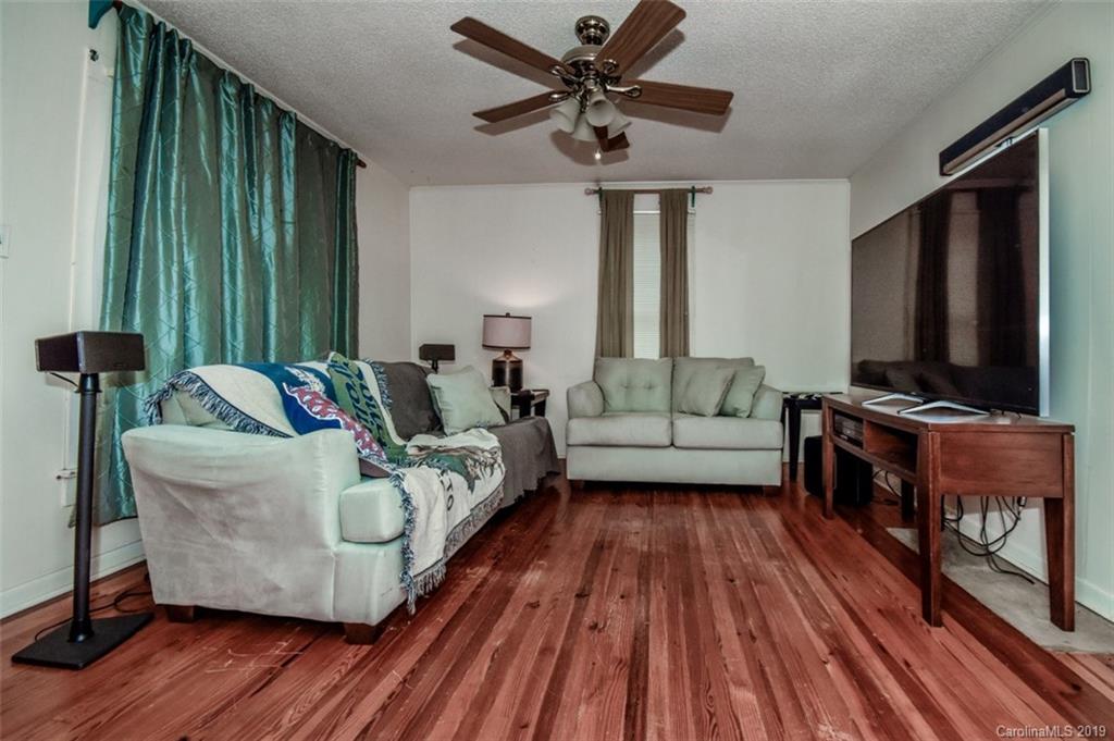 504 Watson Street Davidson, NC 28036 - Photo 23 of 35 a living room with furniture and a flat screen tv
