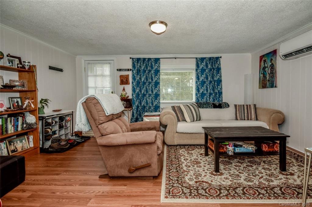 504 Watson Street Davidson, NC 28036 - Photo 31 of 35 a living room with furniture and a book shelf
