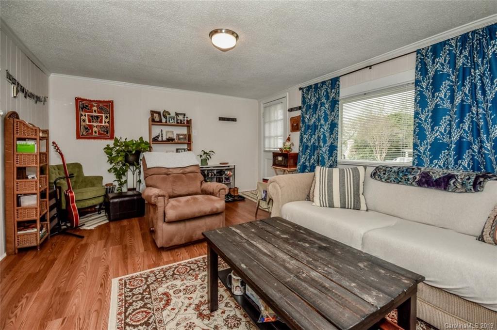 504 Watson Street Davidson, NC 28036 - Photo 32 of 35 a living room with furniture a wooden floor and a large window