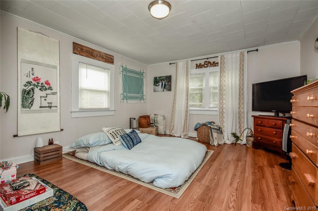 504 Watson Street Davidson, NC 28036 - Photo 33 of 35 a bedroom with a bed and wooden floor