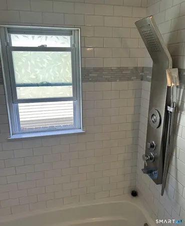 a bathroom with a bathtub and a shower