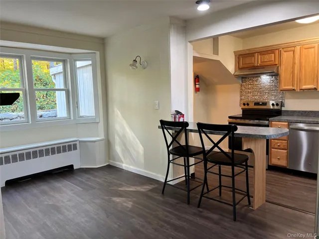 a kitchen that has a table and chair in it
