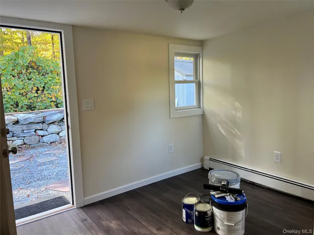 a living room with hard wood flooring and a couch