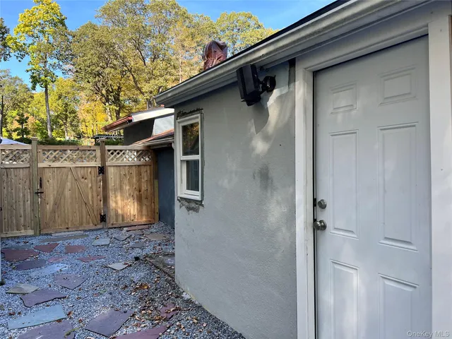 a view of a house with a wooden fence