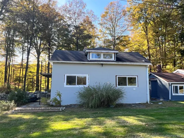 a front view of a house with a yard garage and outdoor seating