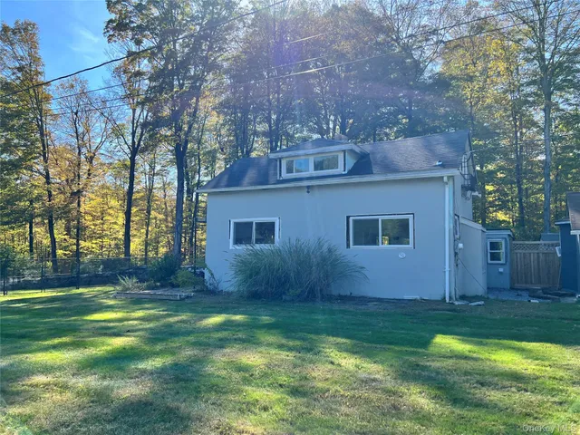 a view of house with backyard