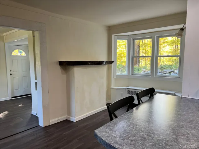 a view of a workspace with wooden floor and a window