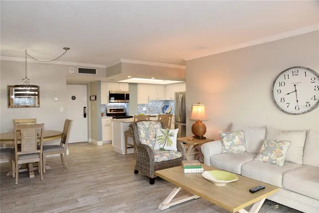 a living room with furniture a dining table and kitchen view