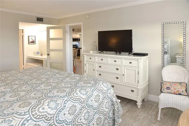 a bedroom with a bed and flat screen tv