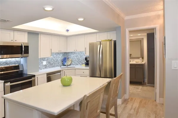 a kitchen with stainless steel appliances a refrigerator and a stove