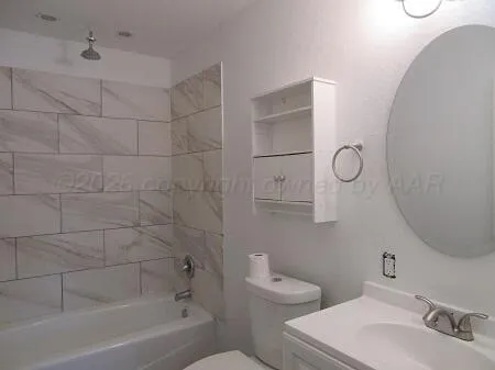 a bathroom with a toilet sink and bathtub