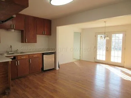 a kitchen with granite countertop a stove a sink and a refrigerator