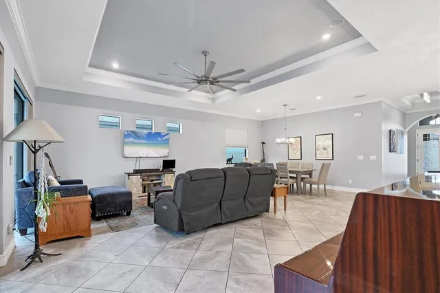 a living room with furniture kitchen view and a flat screen tv