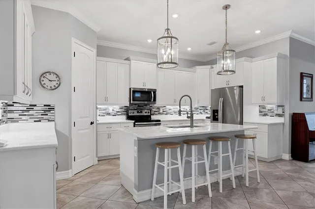 a kitchen with sink a microwave and refrigerator