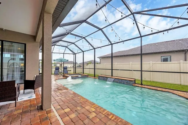 a view of a house with backyard porch and sitting area
