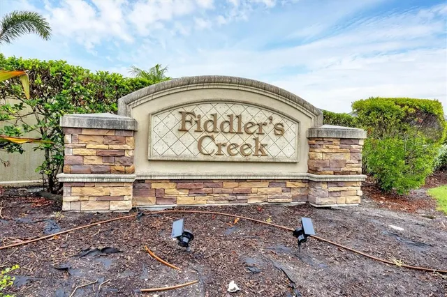 an aerial view of a house with a yard and lake view
