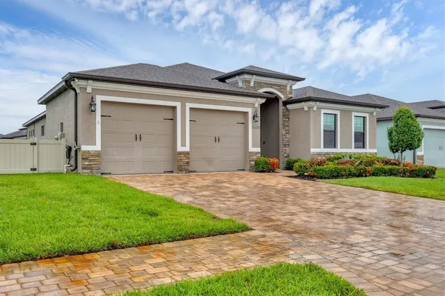 a front view of a house with a yard and garage