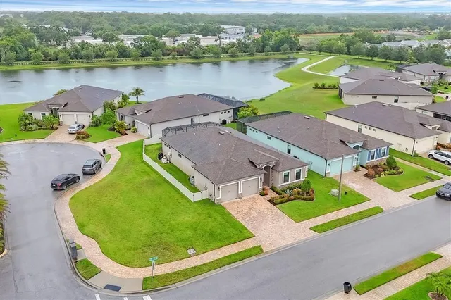 an aerial view of a house with outdoor space and lake view