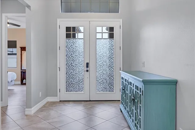 a view of a hallway with wooden door and stairs