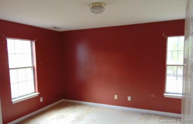10303 Rockwood Road Charlotte, NC 28215 - Photo 2 of 12 an empty room with windows