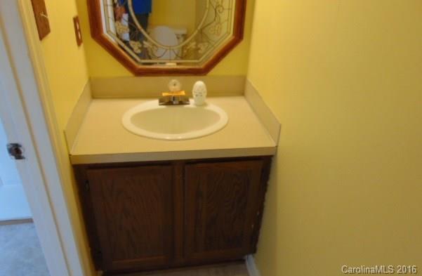 10303 Rockwood Road Charlotte, NC 28215 - Photo 12 of 12 a bathroom with a sink and a mirror