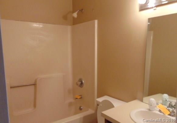 10303 Rockwood Road Charlotte, NC 28215 - Photo 4 of 12 a bathroom with a shower and a toilet