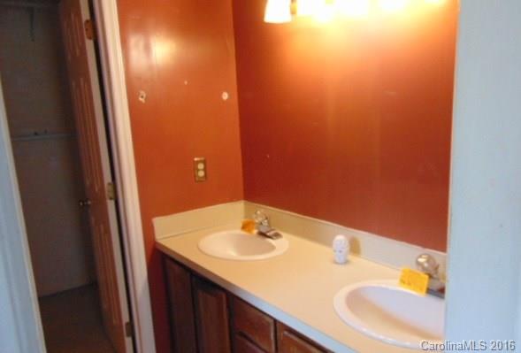 10303 Rockwood Road Charlotte, NC 28215 - Photo 6 of 12 a bathroom with a sink and a mirror