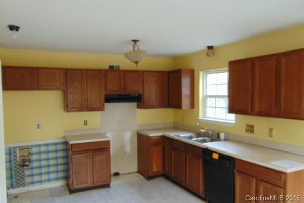10303 Rockwood Road Charlotte, NC 28215 - Photo 8 of 12 a kitchen with granite countertop a sink and a stove