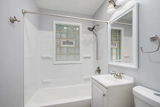 a bathroom with a sink mirror toilet and bathtub
