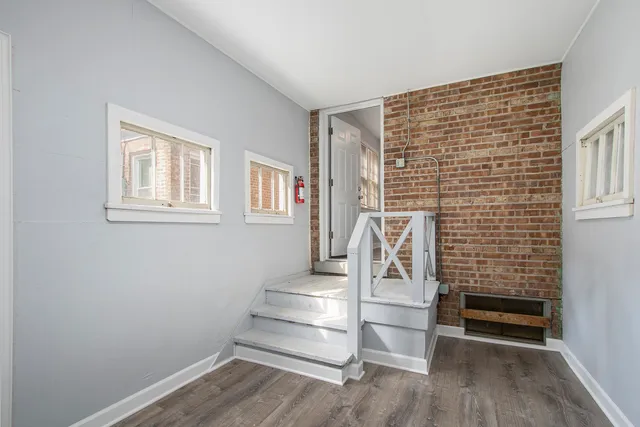 a view of entryway with stairs and wooden floor