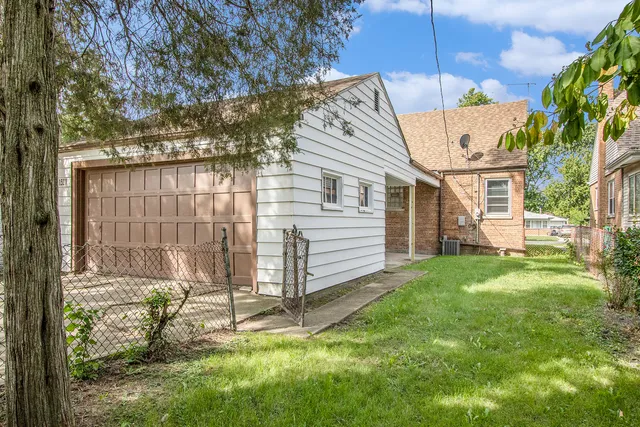 a view of a house with yard and sitting area