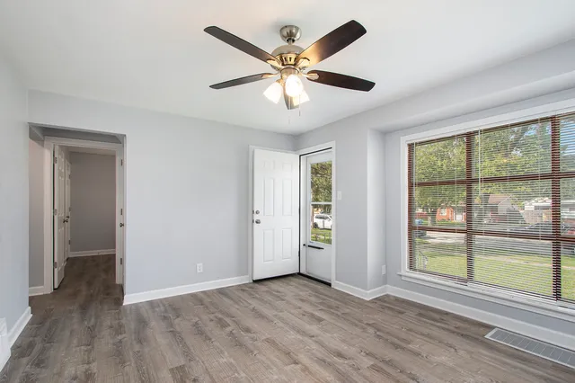 wooden floor in an empty room with a window