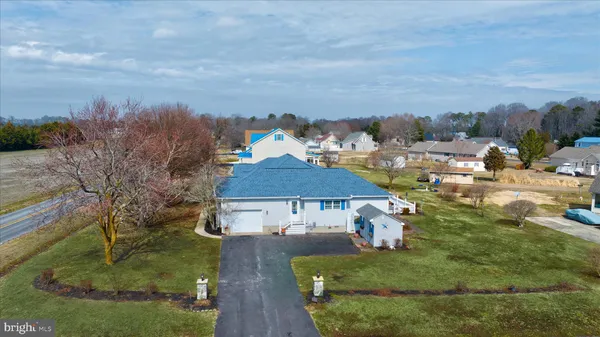 an aerial view of a house with yard swimming pool and outdoor seating