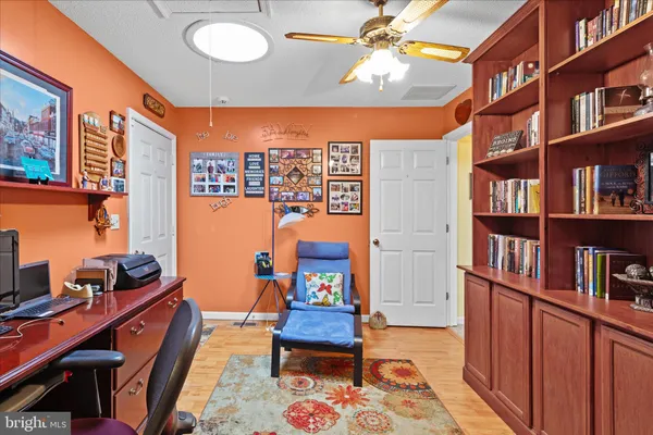 a living room with furniture a chandelier and a large window