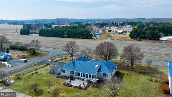 a living room with furniture a flat screen tv and a wall