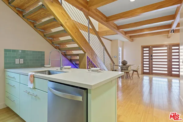 a view of a kitchen with sink and wooden floor