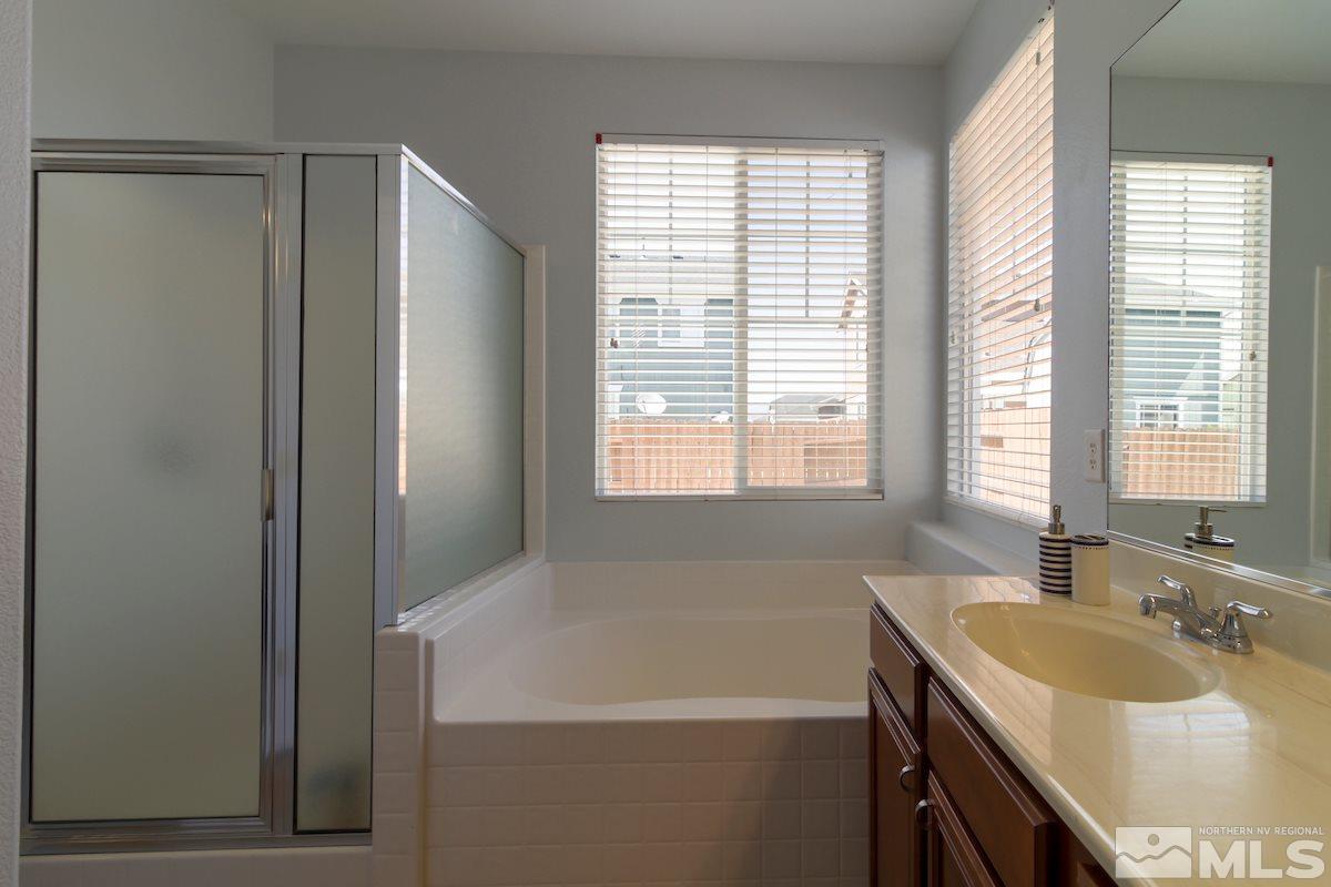 8903 Wynne Street Reno, NV 89506 - Photo 12 of 17 a bathroom with a tub sink and mirror