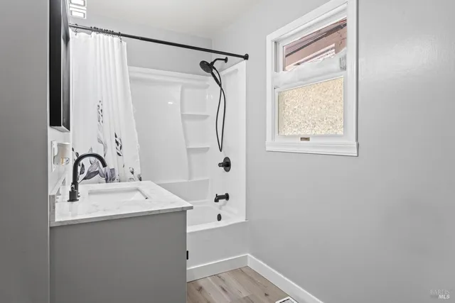 a bathroom with a sink a mirror and a shower