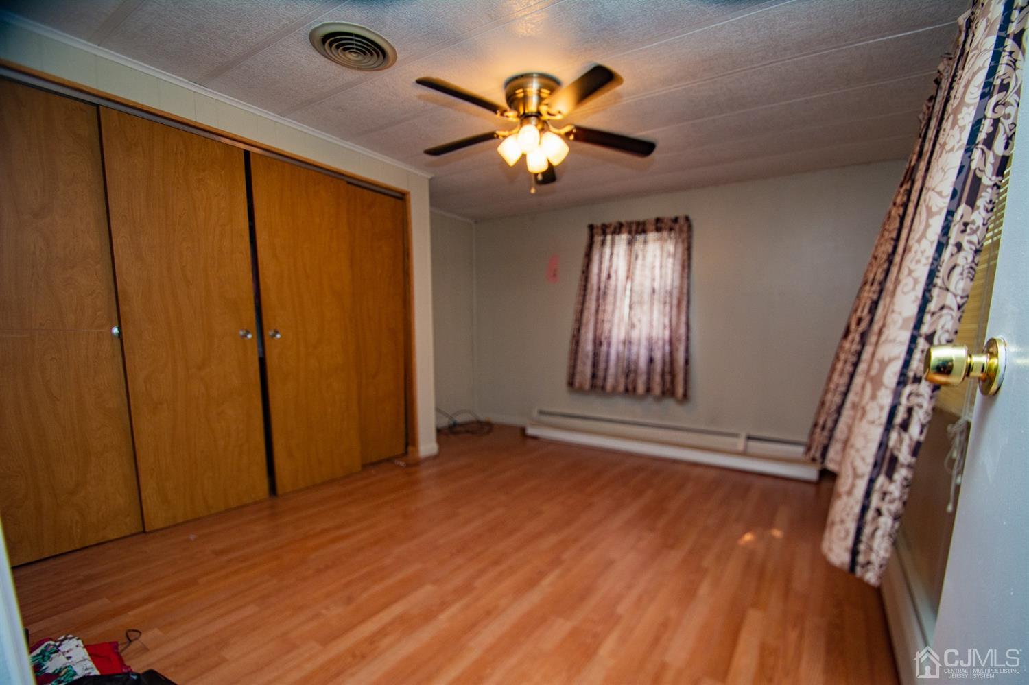 47 Poe Road North Brunswick, NJ 08902 - Photo 11 of 19 wooden floor in an empty room with a window