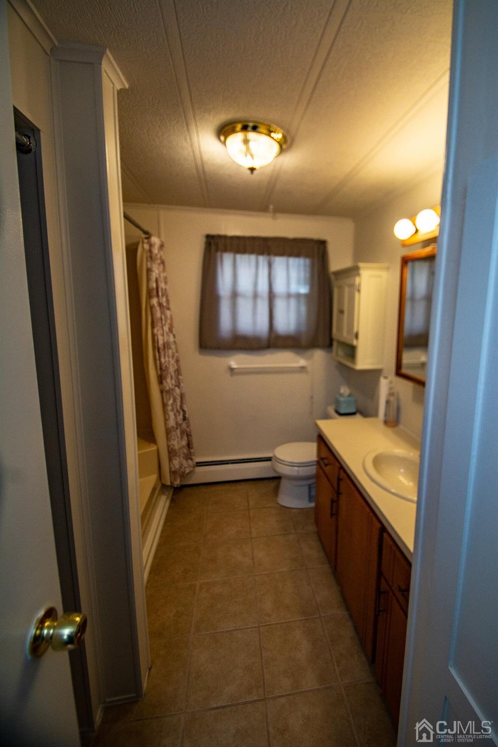 47 Poe Road North Brunswick, NJ 08902 - Photo 13 of 19 a bathroom with a granite countertop sink a mirror and a bathtub
