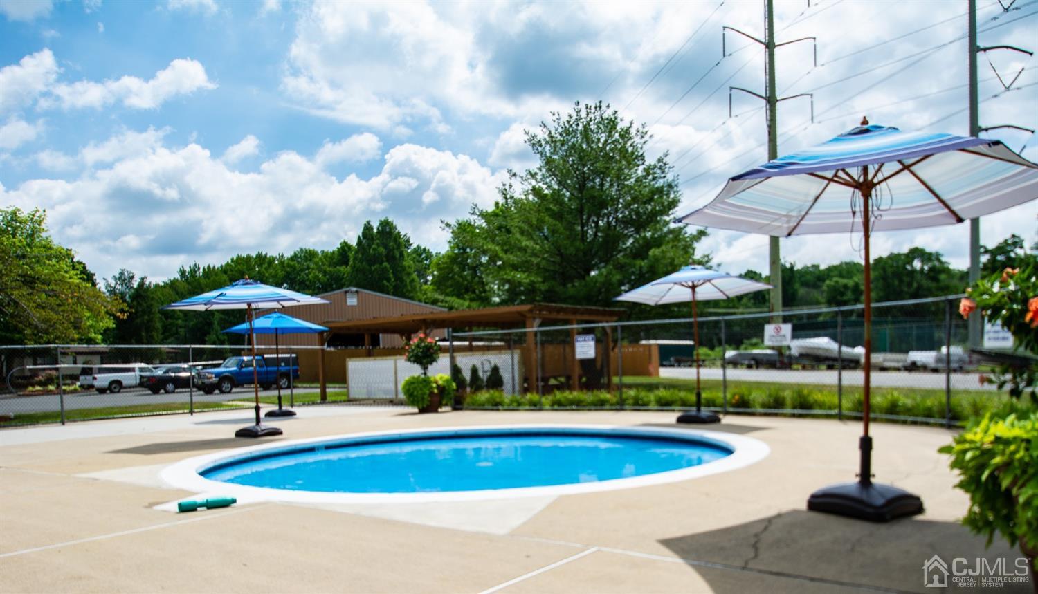 47 Poe Road North Brunswick, NJ 08902 - Photo 17 of 19 a view of pool with table and chairs under an umbrella