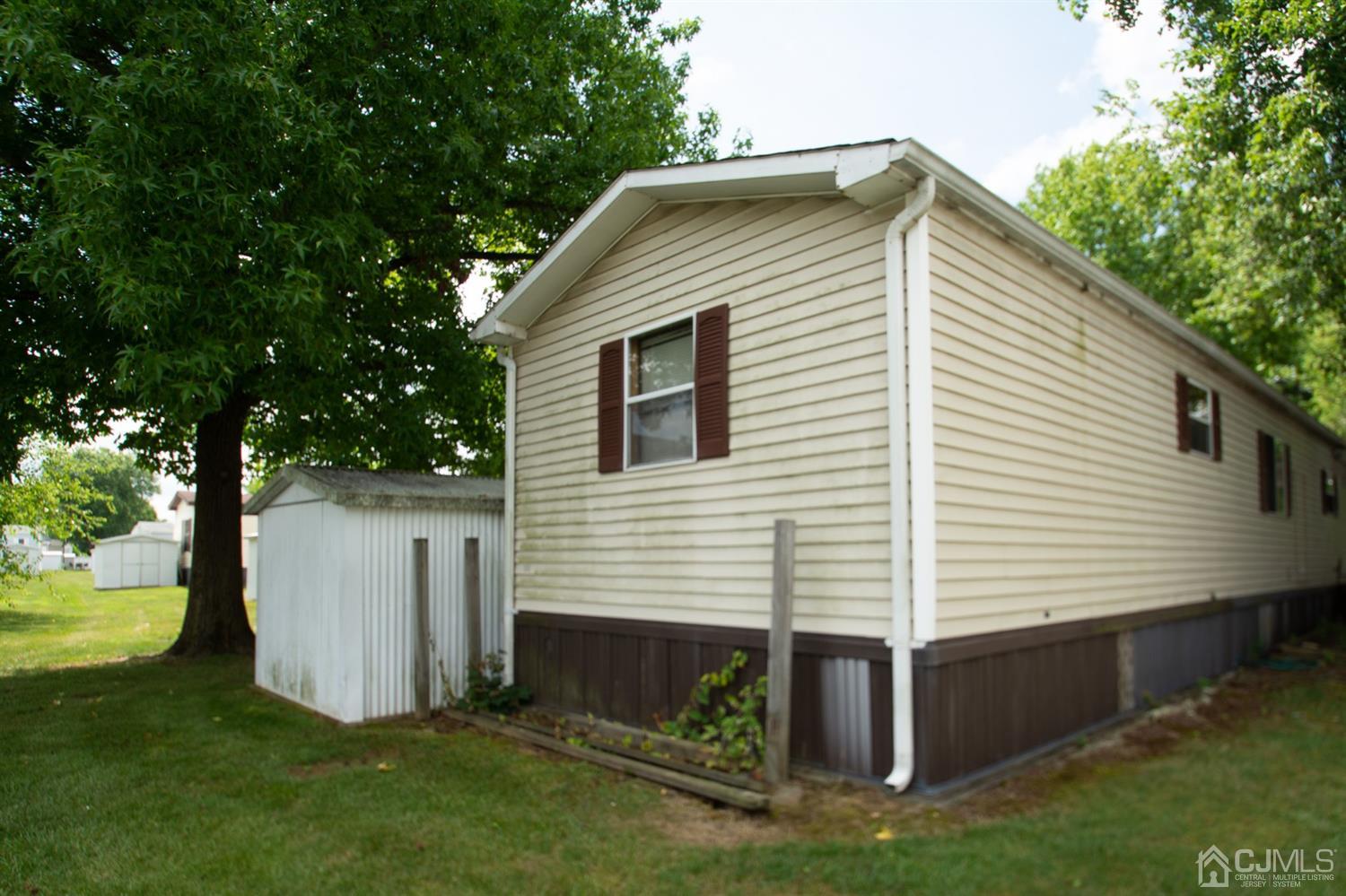 47 Poe Road North Brunswick, NJ 08902 - Photo 4 of 19 a view of backyard with barbeque grill and a large tree