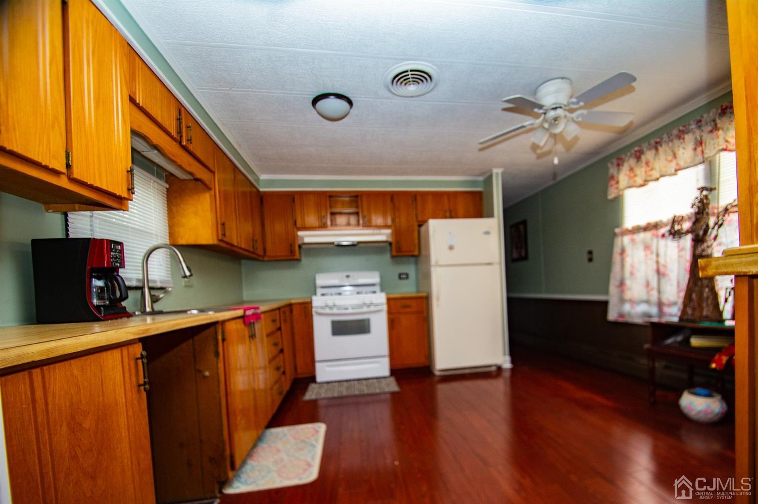 47 Poe Road North Brunswick, NJ 08902 - Photo 7 of 19 a kitchen with stainless steel appliances granite countertop a refrigerator a sink dishwasher and a stove with wooden floor