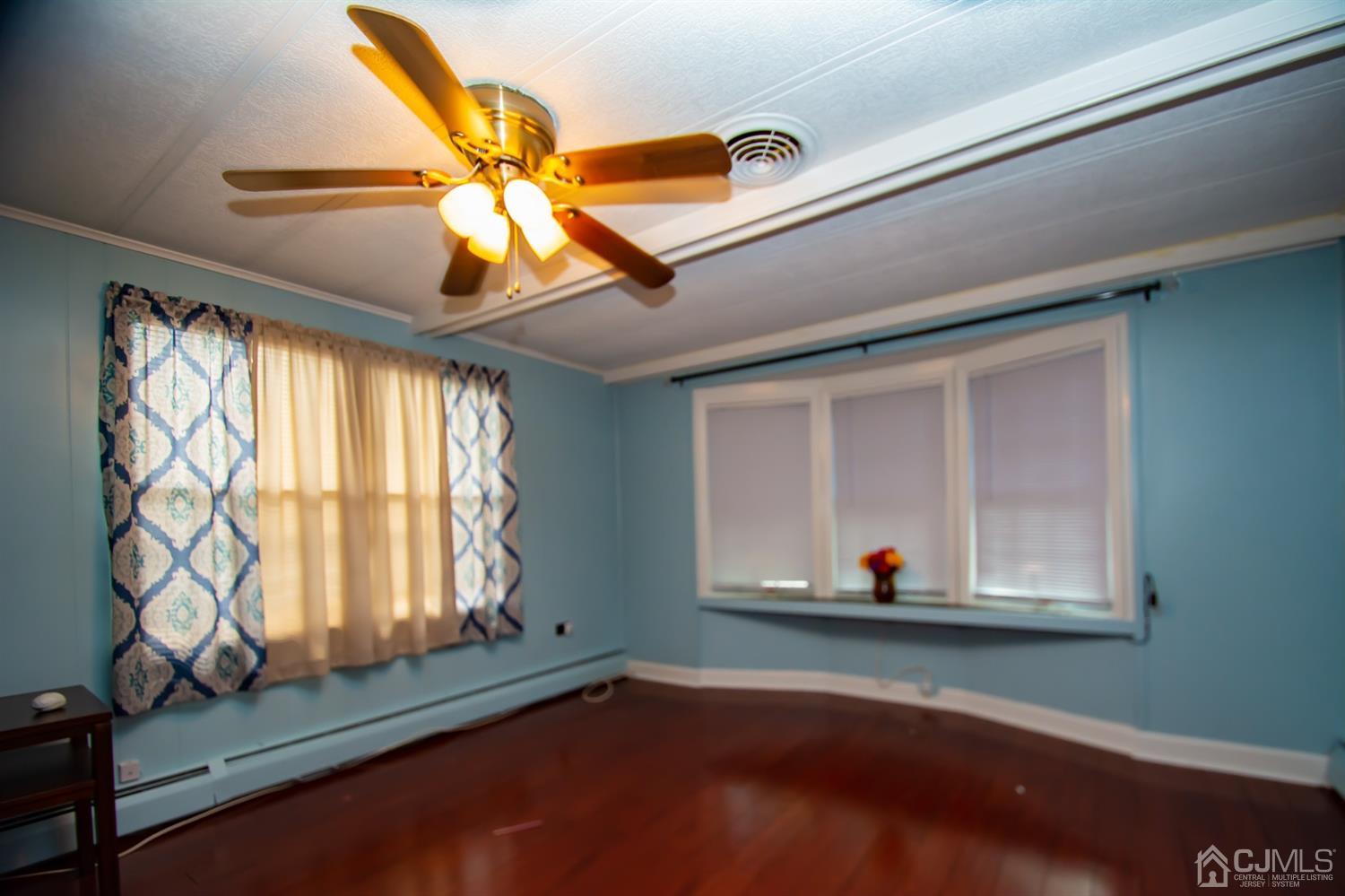 47 Poe Road North Brunswick, NJ 08902 - Photo 8 of 19 a room with wooden floor and window
