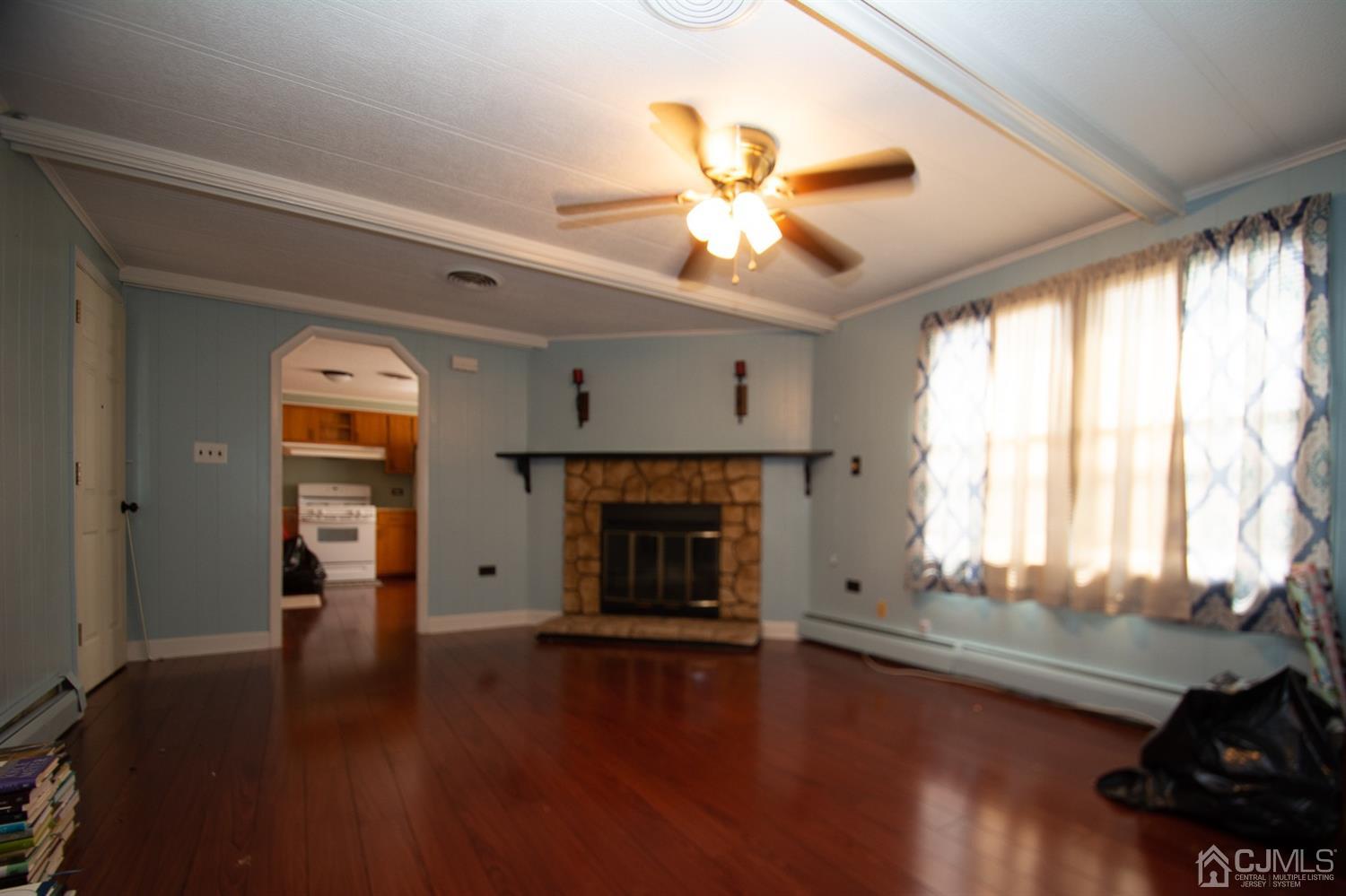 47 Poe Road North Brunswick, NJ 08902 - Photo 10 of 19 a view of an empty room with wooden floor and a window