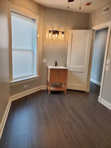 a view of a room with wooden floor and cabinet
