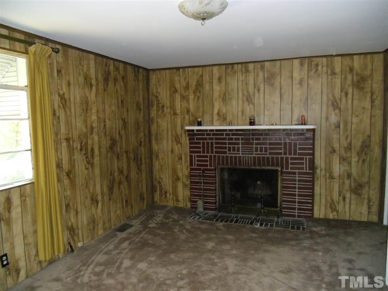 2304 Cheek Road Durham, NC 27704 - Photo 3 of 8 a living room with a fireplace