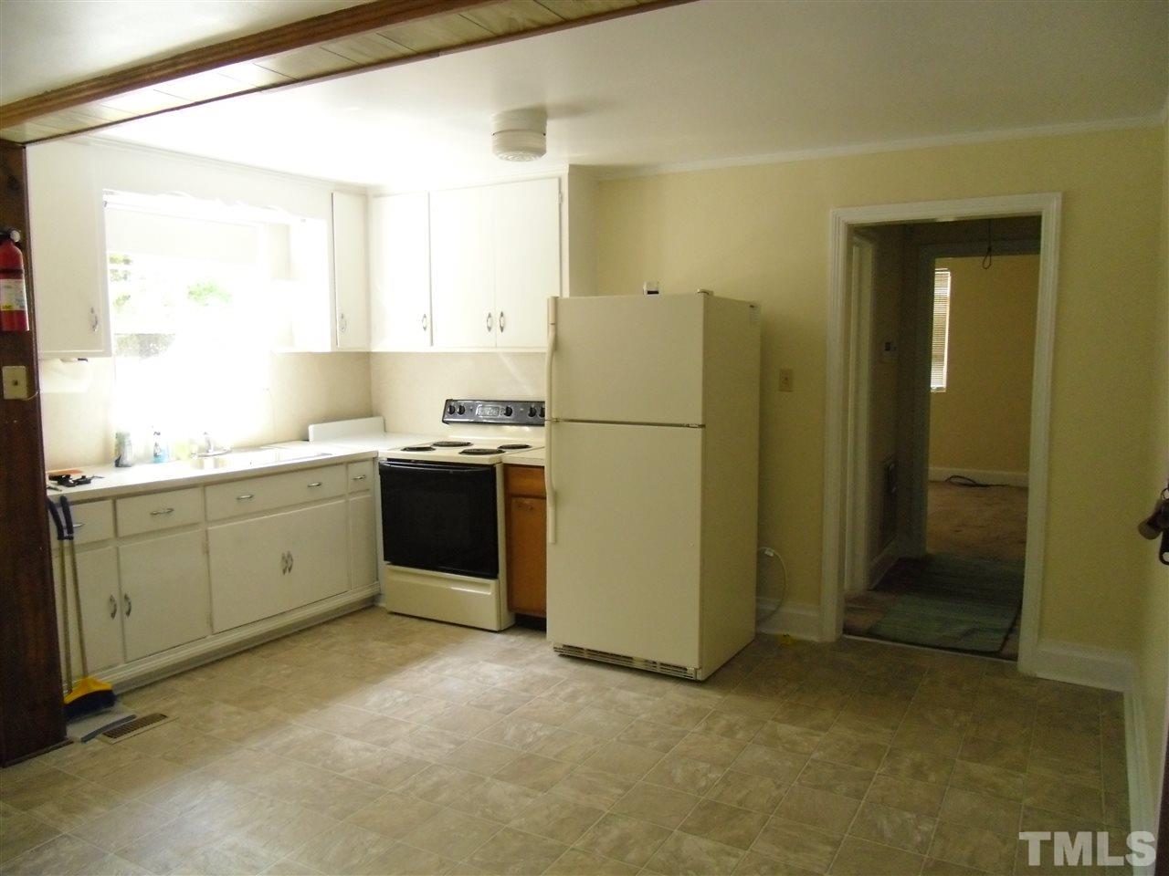 2304 Cheek Road Durham, NC 27704 - Photo 4 of 8 a kitchen with a refrigerator sink and cabinets